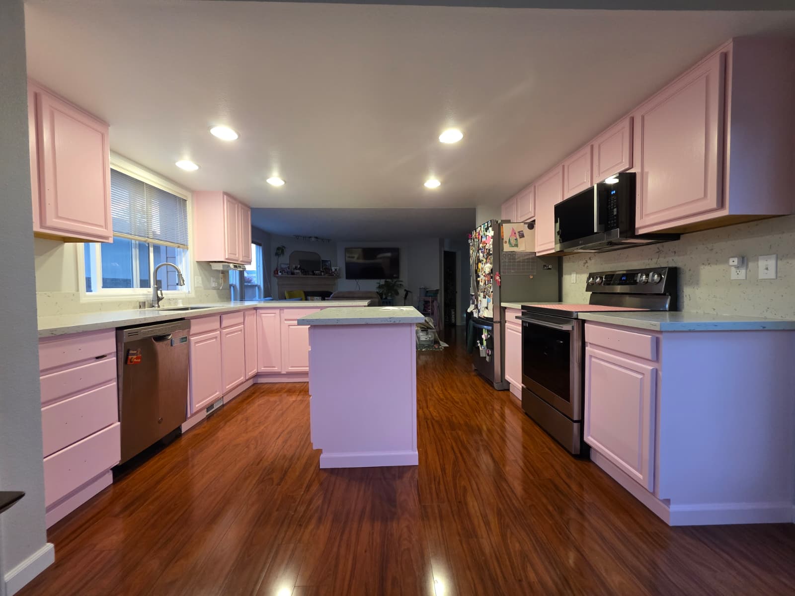 Finished kitchen with cabinets refinished in a soft pink and clean white ceiling